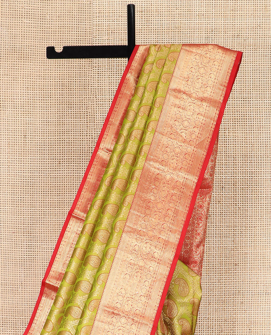 Green Kanchipuram Silk Saree Delicately Woven with Manga Jacquard Design, Complemented by Contrast Border of Thilakam, Chakram, Manga, Kodi Visiry,  Mayil, and Jada Nagam Designs, Pallu Gleamed Up with Jaal Designs, and Paired with a Contrast Blouse