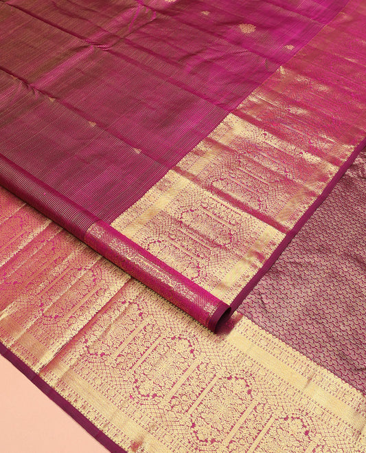 Purple zari stripes and buttas Kanchipuram silk saree,  zari border of thilakam, poun, and MUghal-style floral designs, and pallu steeped with manga motifs