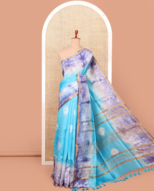 Blue Banana Pith Saree Beautified with Shibori Prints, Subtly Made Zari Bavanji Border, Pallu Featuring Zari Stripes and Shibori Print, and Paired with a Matching Shibori Printed Blouse