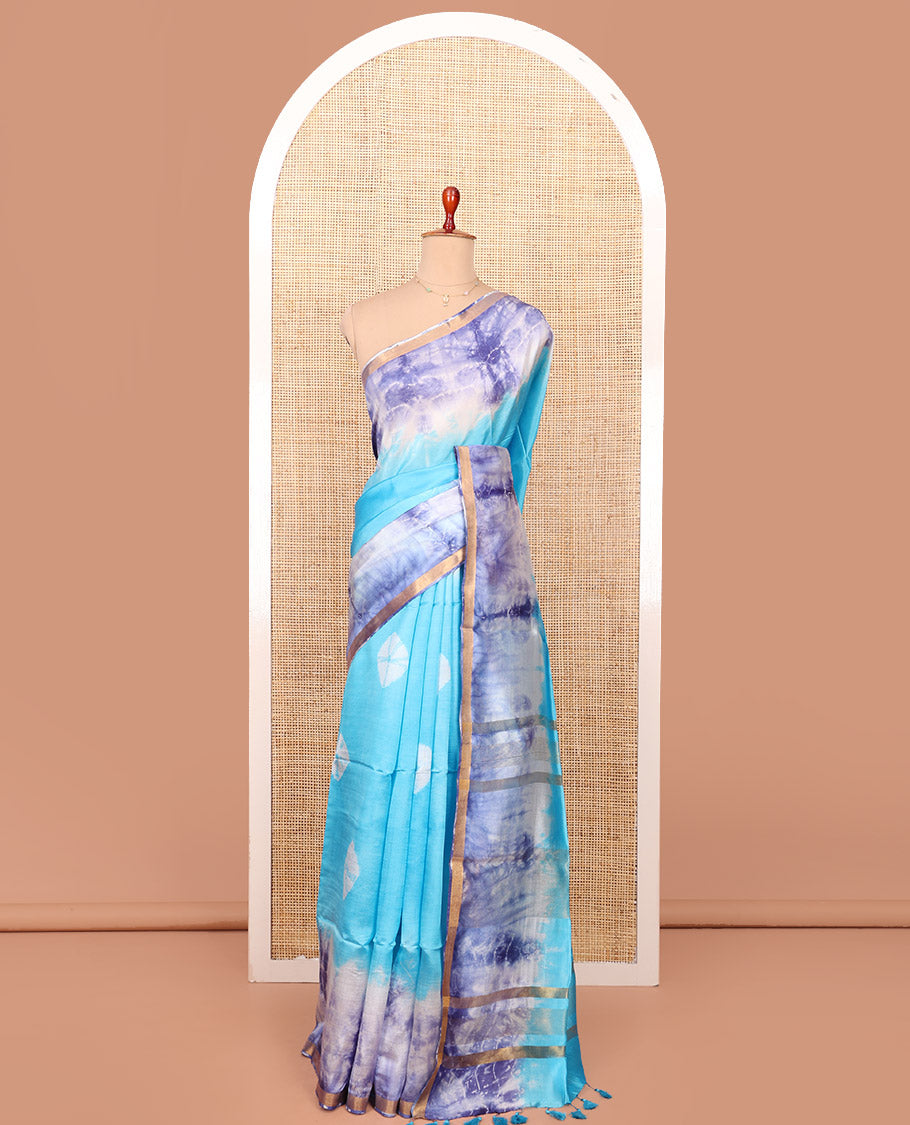 Blue Banana Pith Saree Beautified with Shibori Prints, Subtly Made Zari Bavanji Border, Pallu Featuring Zari Stripes and Shibori Print, and Paired with a Matching Shibori Printed Blouse