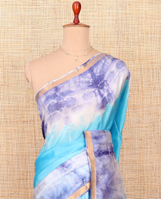 Blue Banana Pith Saree Beautified with Shibori Prints, Subtly Made Zari Bavanji Border, Pallu Featuring Zari Stripes and Shibori Print, and Paired with a Matching Shibori Printed Blouse