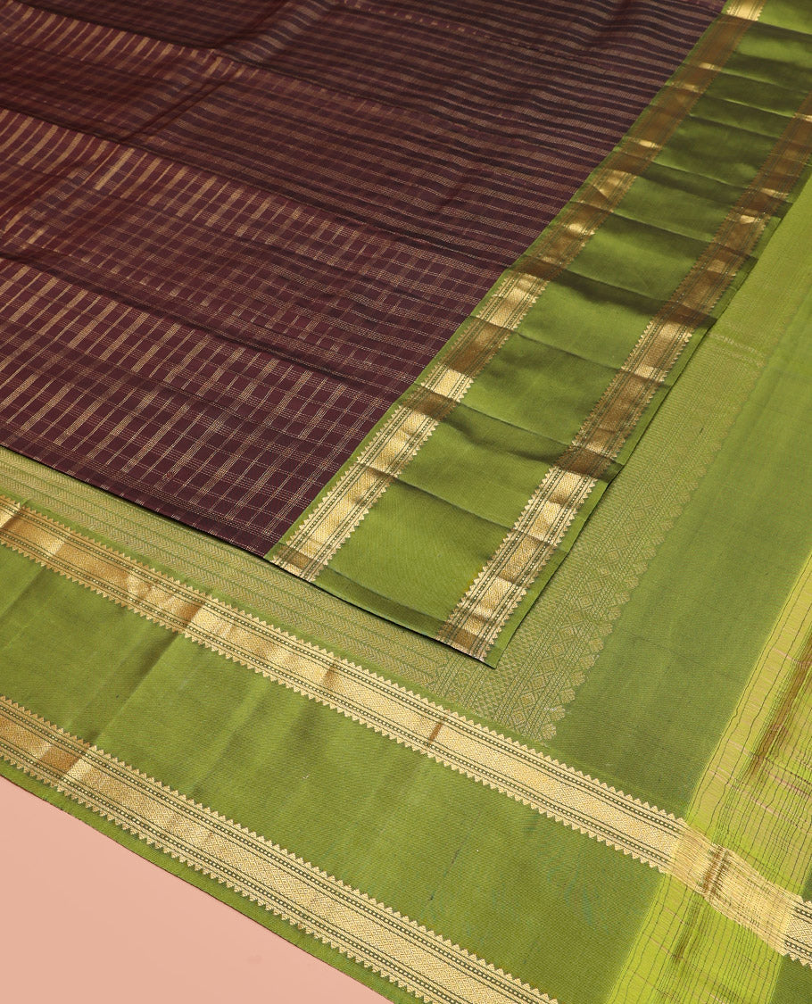 Brown Vasundhara Silk Saree Adorned with Zari Checks, Highlighted by a Contrast Rettai Pettu Border of Rekku, Muthu, Banaras, and Mayil Kann Designs, a Zari-Woven Pallu of Kathir Designs, and Paired with a Contrast Blouse