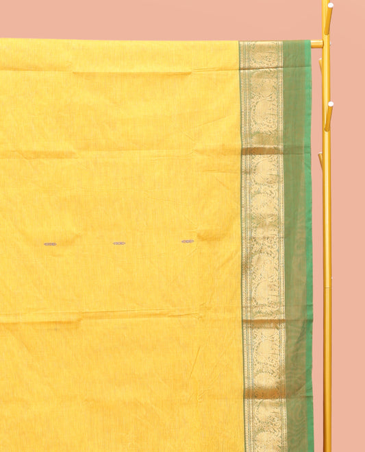 Yellow Chettinad Cotton Saree, Finely Crafted with Thread Buttas All Over Its Body, Complemented by a Contrast Ganga-Jamuna Kal Eragina Border of Kodi Peacock and Elephant Designs, Pallu of Buttas and Stripes, and Paired with a Matching Blouse