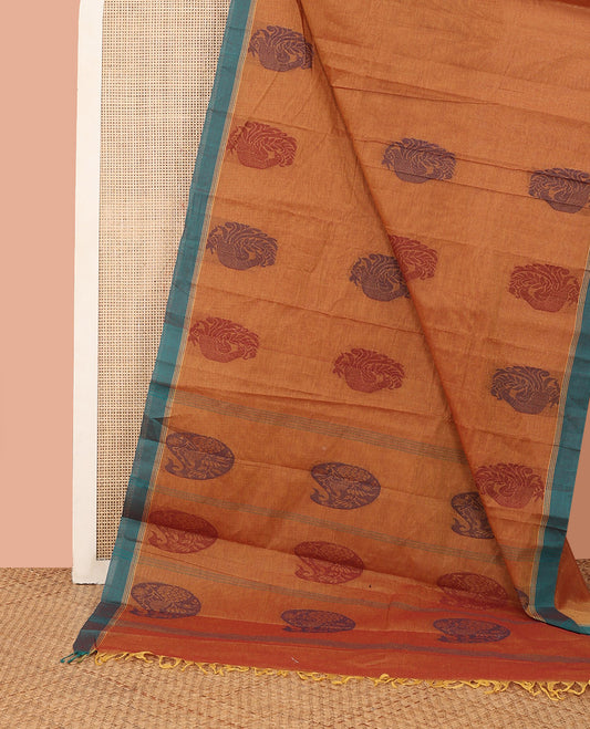 Orange Kanchi Cotton Saree, Beautified with Peacock Buttas All Over Its Body, Complemented by Contrast Border, Pallu Steeped with Flower Vase Designs, and Paired with a Matching Blouse