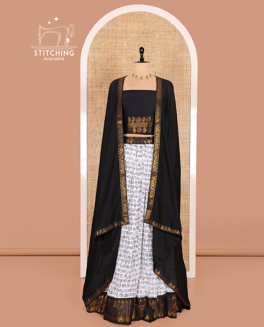 White and Black Printed Sungudi Cotton Half-Saree Showcasing a Skirt Printed with Tamil Letters, Accentuated by a Contrast Traditional Zari Border, a Contrast Blouse, and a Plain Zari-Bordered Dhavani