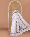 White jingle bell and Christmas tree motifs printed linen saree with bavanji borders, Santa Claus figure printed pallu, and a contrast jingle bell printed blouse