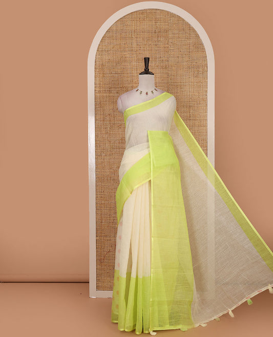 Cream full-plain linen saree, contrast parrot green big plain border, plain pallu & buttas printed matching blouse