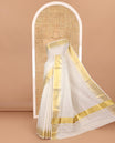 Cream golden zari checked woven Kerala cotton saree, zari temple bavanji border, striped pallu, and a matching blouse