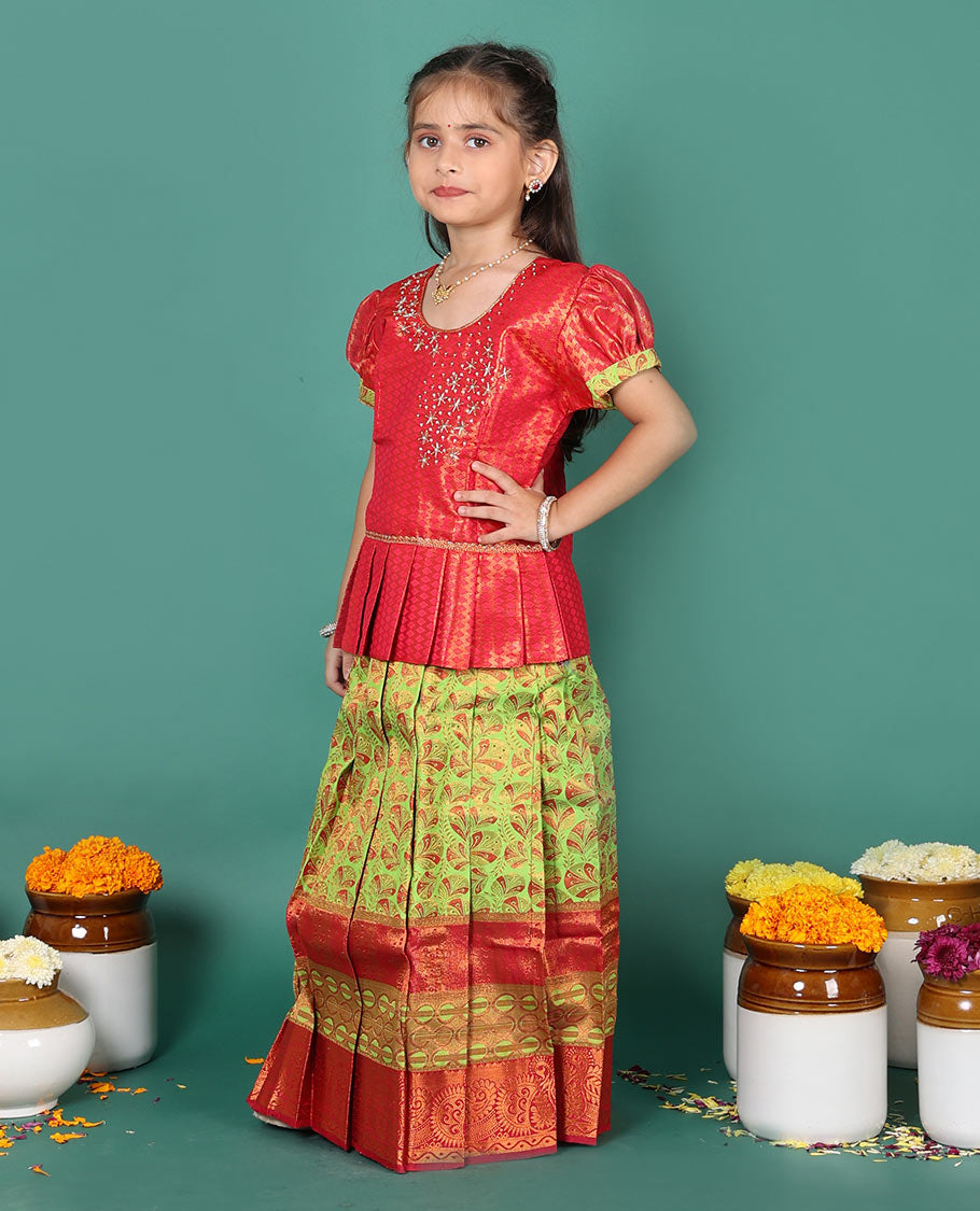 Green readymade art silk pavadai set, floral jacquard with contrast traditional zari border skirt, and contrast jacquard embroidered puff-sleeve blouse
