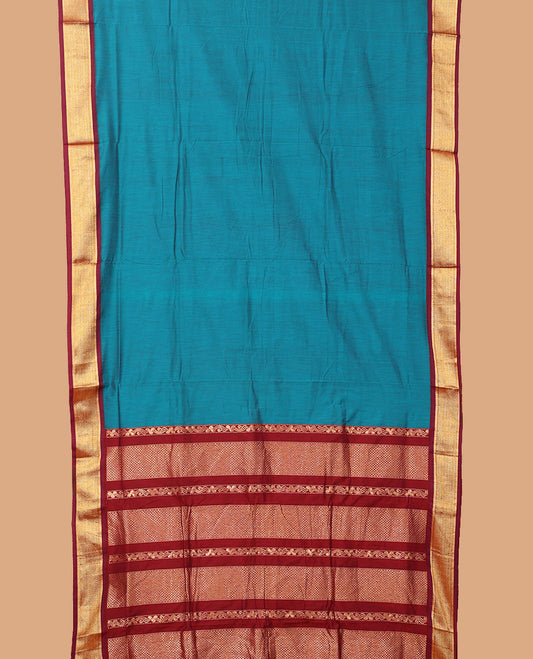 Blue plain nine-yard cotton saree, contrast traditional zari border, and pallu of traditional designs