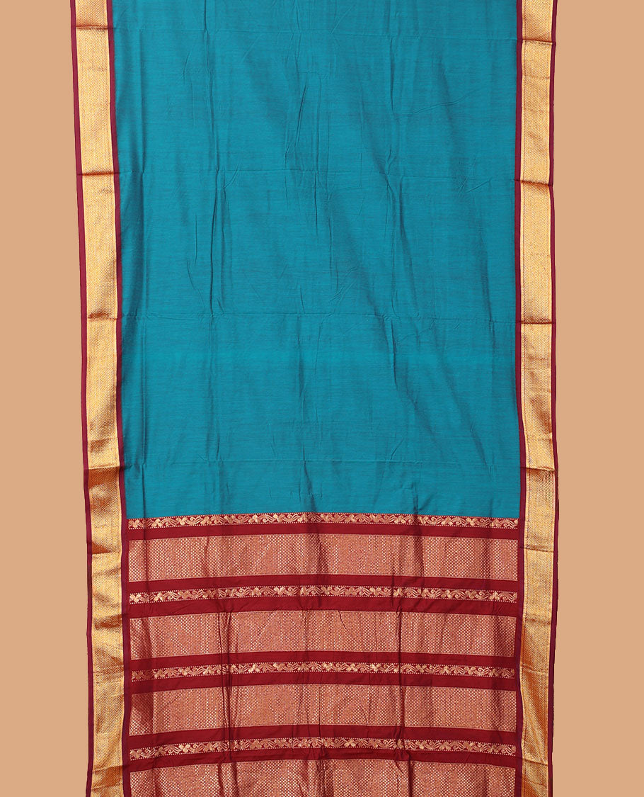Blue plain nine-yard cotton saree, contrast traditional zari border, and pallu of traditional designs