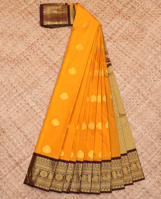 Orange Budget Silk Saree, Showcasing Zari Buttas All Over Its Body, Complemented by a Contrast Traditional Zari Border of Peacock-Chakram Designs, a Pallu of Grand Jaal Design, and Paired with a Contrast Blouse