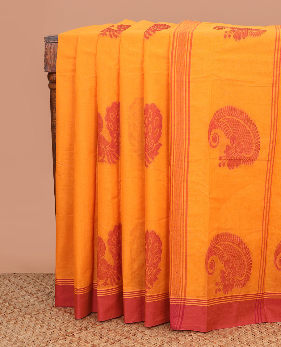 Orange peacock buttas kanchi cotton saree, contrast plain border, and paisley motif pallu