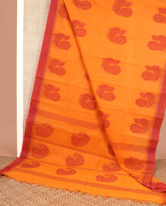Orange peacock buttas kanchi cotton saree, contrast plain border, and paisley motif pallu
