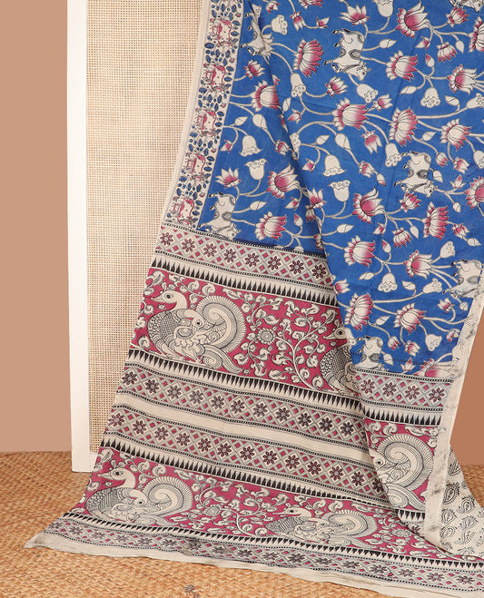 Blue floral vine and bird machine-printed Kalamkari cotton saree, contrast Pichwai cow border, and pallu of floral-peacock designs