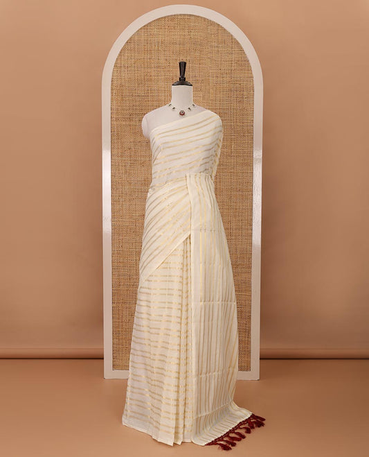 Borderless cream Veldhari-style striped Kerala cotton saree, zari design pallu with maroon tussels & zari design blouse