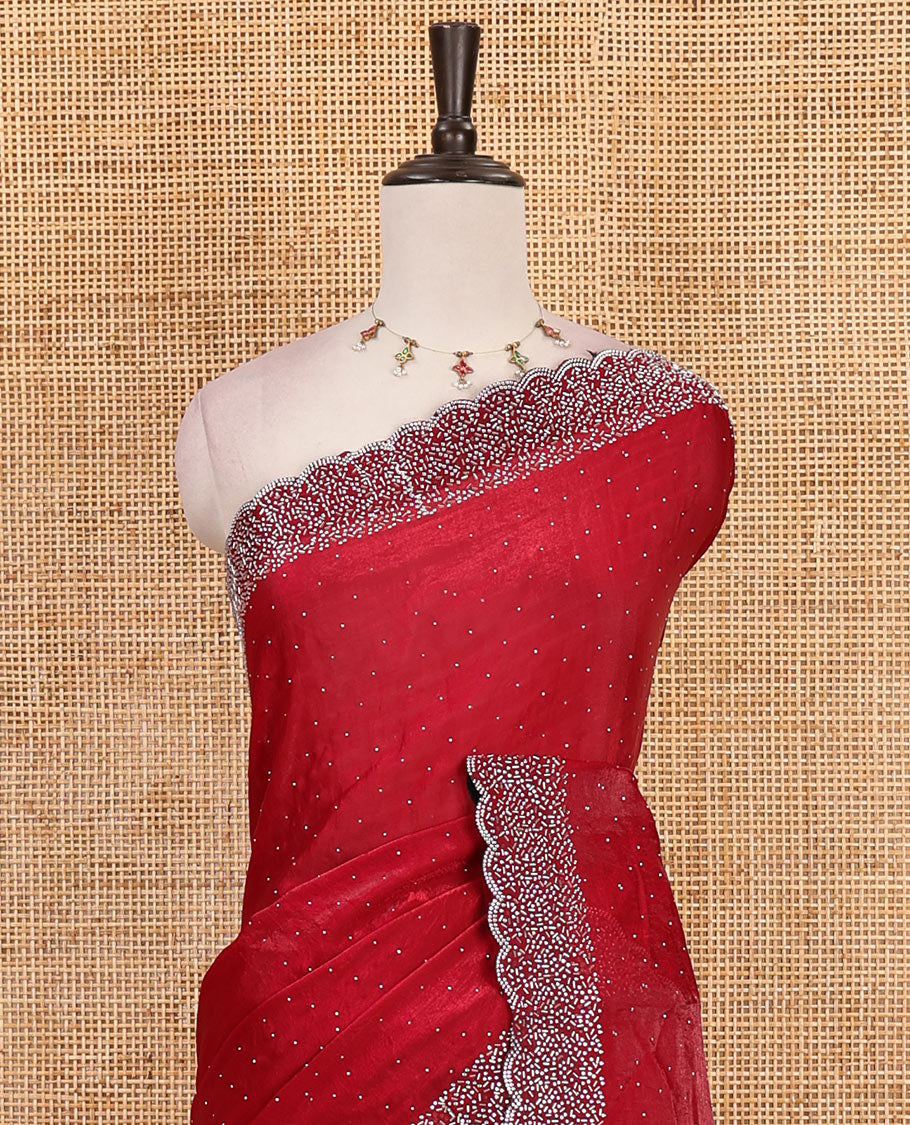 Maroon Swarovski crystal stone embedded fendy chiffon saree, scallop Swarovski stone embroidered border, and contrast plain blouse