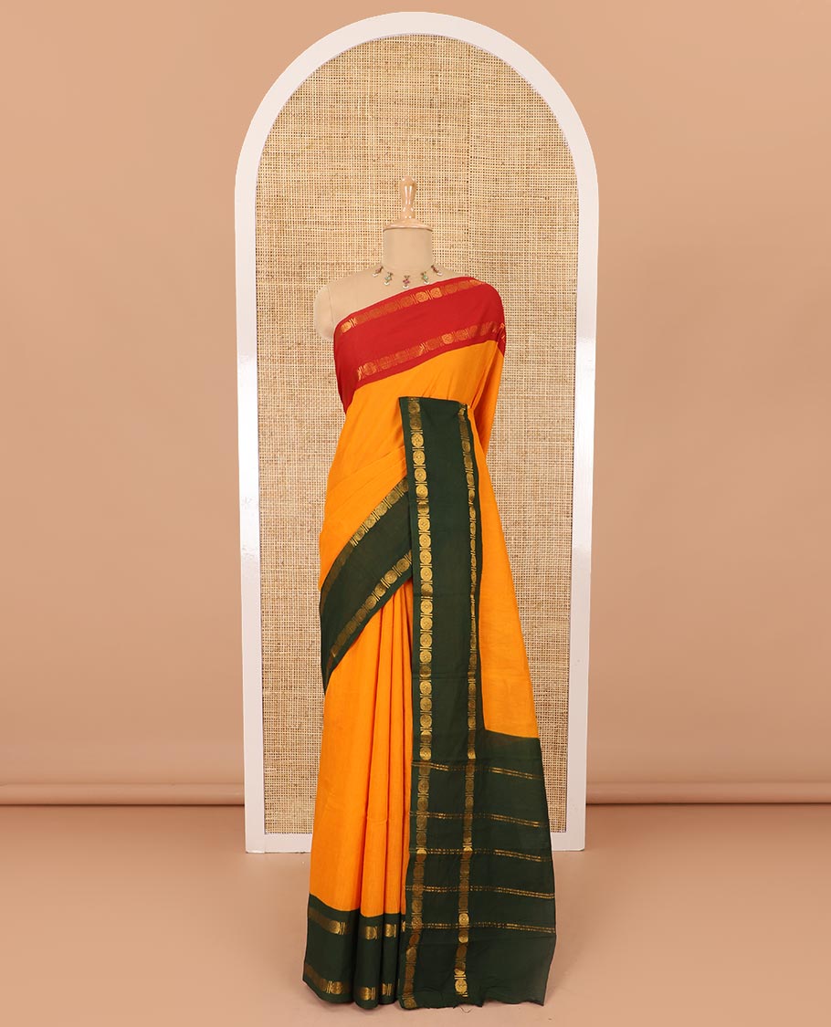 Orange plain sungudi cotton saree with contrast ganga jamuna rettai pettu zari border, zari striped pallu, and contrast veldhari striped blouse