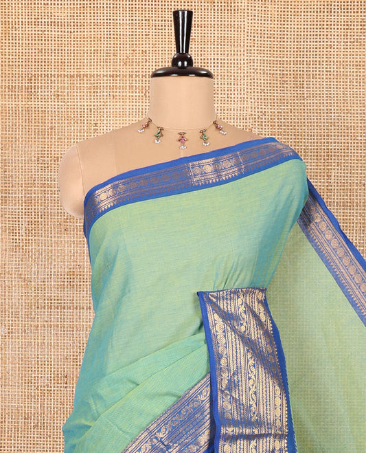 Blue-Green Double-Shade Plain Chettinad Cotton Saree, Complemented by Contrast Border Steeped with Traditional Zari Designs, Subtly Striped Pallu, and Paired with a Matching Blouse