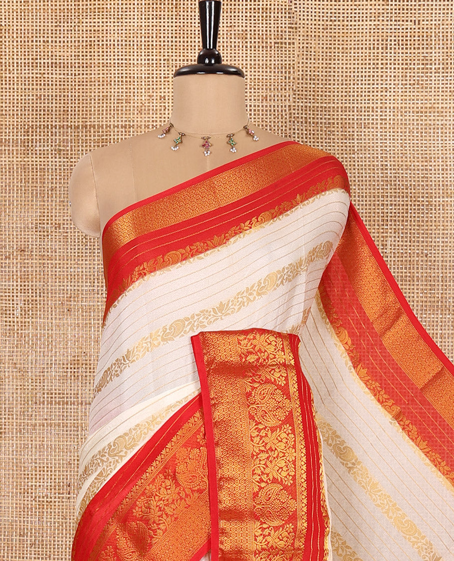 White Moss Chiffon Saree, Beautified with Horizontal Stripes, Peacock, and Floral Buttas All Over Its Body, Complemented by a Contrast Traditional Zari Border, Pallu Mirrors the Same Design, and Paired with a Contrast Floral-Paisley Blouse