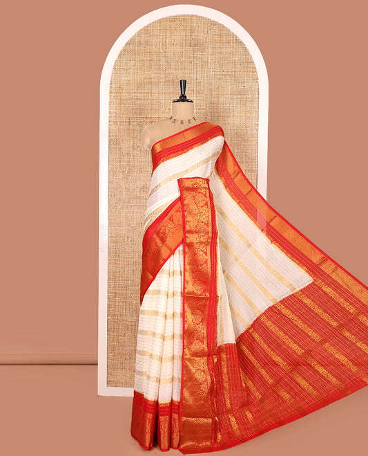 White Moss Chiffon Saree, Beautified with Horizontal Stripes, Peacock, and Floral Buttas All Over Its Body, Complemented by a Contrast Traditional Zari Border, Pallu Mirrors the Same Design, and Paired with a Contrast Floral-Paisley Blouse