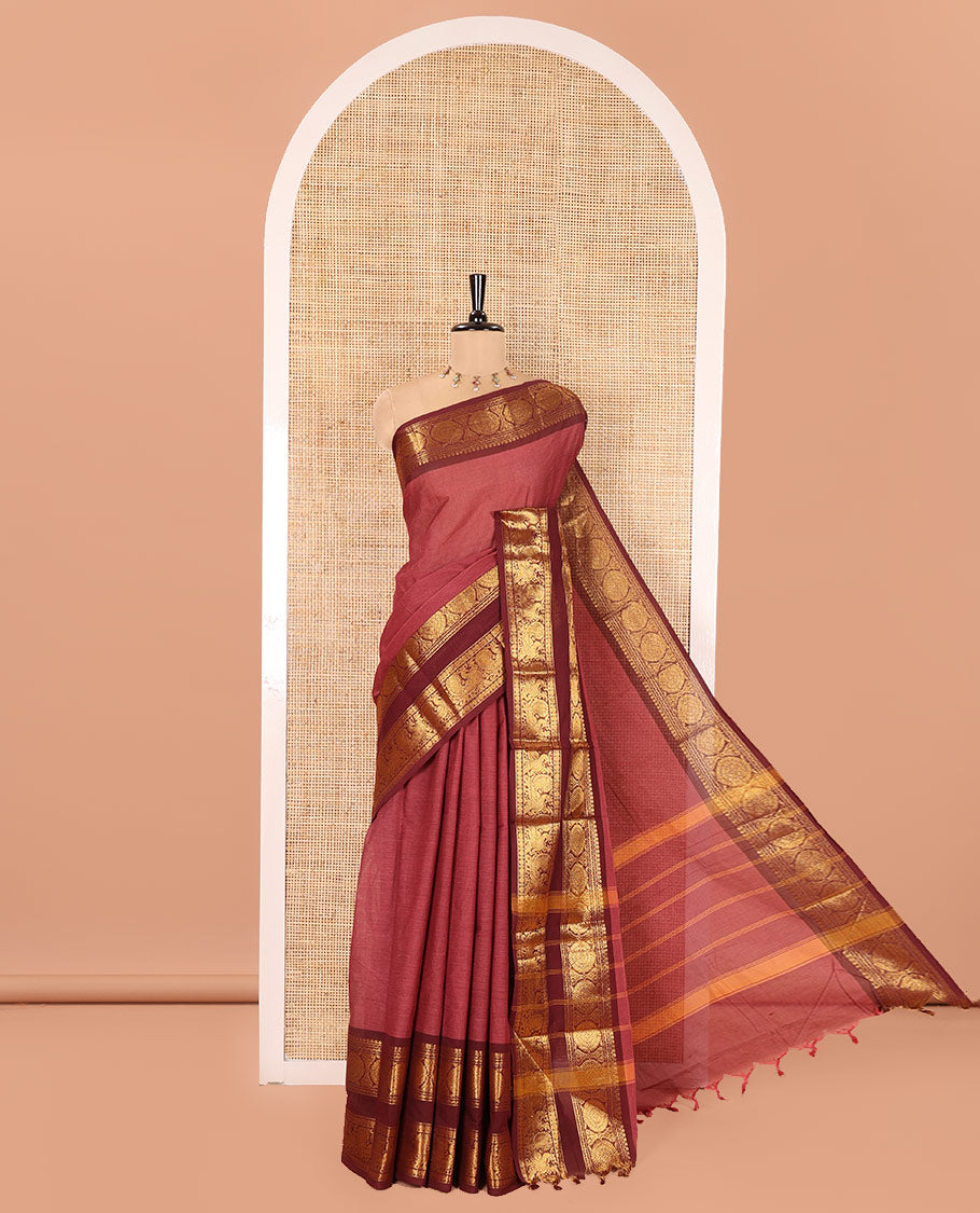 Reddish Brown Plain Chettinad Cotton Saree, Complemented by a Contrast Traditional Zari Border of  Peacock-Chakram Designs, Subtly Striped Pallu, and Paired with a Matching Blouse