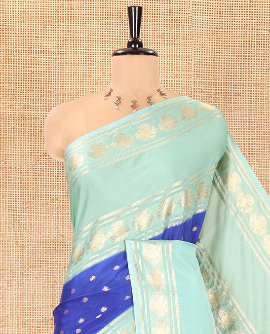 Royal Blue Art Mysore Silk Saree, Enriched with Zari Buttas All Over Its Body, Complemented by a Contrast Rettai Pettu Border of Two-Headed Eagle Designs, Pallu Steeped with Buttas and Stripes, and Paired with a Contrast Blouse