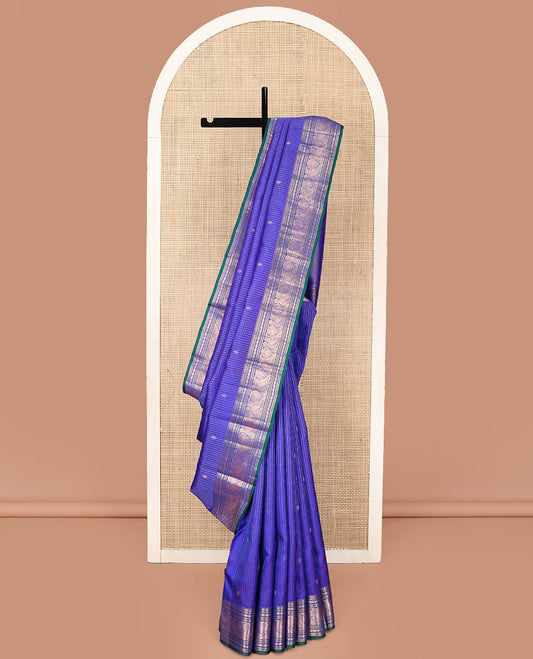Blue Vasundhara Silk Saree, Subtly Sparkled with Zari Buttas and Micro-Checks on Its Body, Highlighted by a Zari Border of Rekku, Banaras, Muthu, Rudraksham, and Mayil Designs, Diagonally Striped Pallu, and Paired with a Contrast Blouse