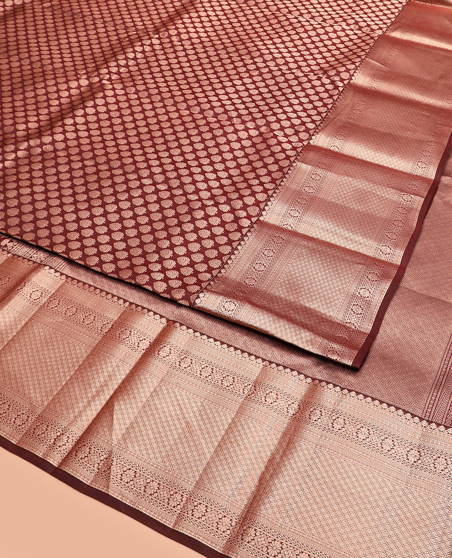Brown Kanchipuram Silk Saree Enlivened with Zari Buttas, Complemented by Zari Border of Kathir, Neli, Kamalam, Chakram,  Manga, and Mayil Kann Designs, Pallu Decked Up with Mayil Kann Designs, and Paired with a Matching Blouse