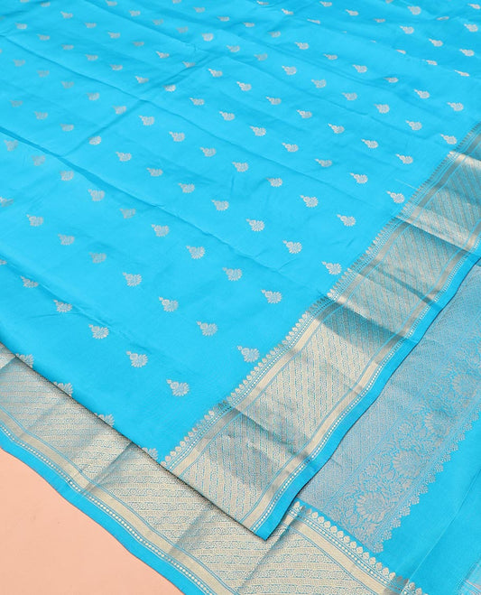 Blue Vasundhara Lite Silk Mix Saree, Adorned with Zari Buttas All Over Its Body, Highlighted by Zari Border of Thilakam Mokku, and Kodi Visiry Designs, Grand Jaal Pallu, and Paired with a Matching Blouse