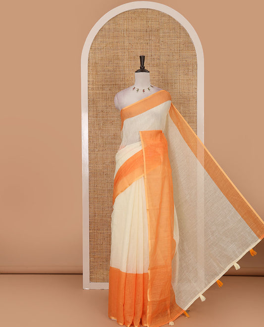 Cream full-plain linen saree, contrast orange big plain border, plain pallu & buttas printed matching blouse