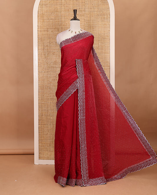 Maroon Swarovski crystal stone embedded fendy chiffon saree, scallop Swarovski stone embroidered border, and contrast plain blouse