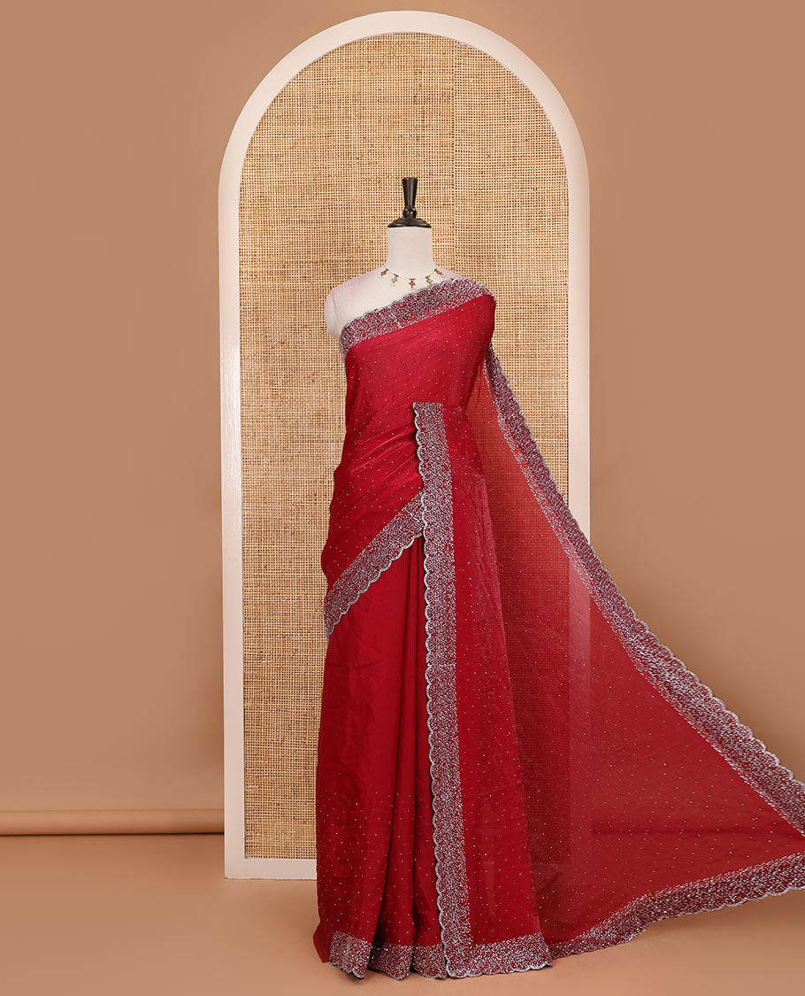 Maroon Swarovski crystal stone embedded fendy chiffon saree, scallop Swarovski stone embroidered border, and contrast plain blouse