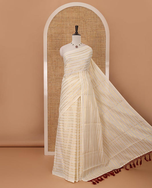 Borderless cream Veldhari-style striped Kerala cotton saree, zari design pallu with maroon tussels & zari design blouse