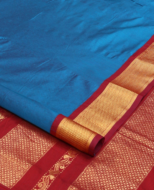 Blue plain nine-yard cotton saree, contrast traditional zari border, and pallu of traditional designs