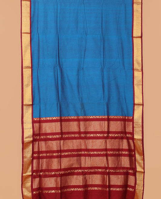 Blue plain nine-yard cotton saree, contrast traditional zari border, and pallu of traditional designs