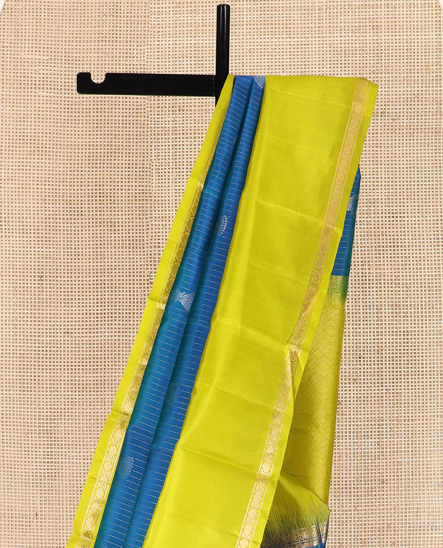 Blue Kanchipuram Silk Saree, Sparsely Sparkled with Muthu Stripes and Jhumka Buttas All Over Its Body, Complemented by a Contrast Rettai Pettu Border of Thilakam Mokku, and Laddu Kamalam Designs, Subtly Sparkled Pallu, and Paired with a Contrast Blouse