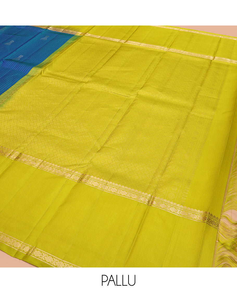 Blue Kanchipuram Silk Saree, Sparsely Sparkled with Muthu Stripes and Jhumka Buttas All Over Its Body, Complemented by a Contrast Rettai Pettu Border of Thilakam Mokku, and Laddu Kamalam Designs, Subtly Sparkled Pallu, and Paired with a Contrast Blouse