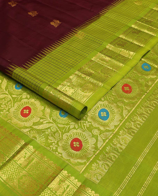 Maroon kancheepuram silk saree with zari buttas, contrast one-sided thazampoo reku checked border of mayil chakram designs & pallu of meenakari floral motifs