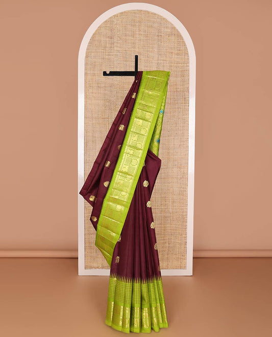 Maroon kancheepuram silk saree with zari buttas, contrast one-sided thazampoo reku checked border of mayil chakram designs & pallu of meenakari floral motifs
