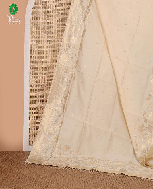Cream zari thilakam buttas tissue silk saree, zari-woven border, pallu of pichwai lotus designs & zari design blouse