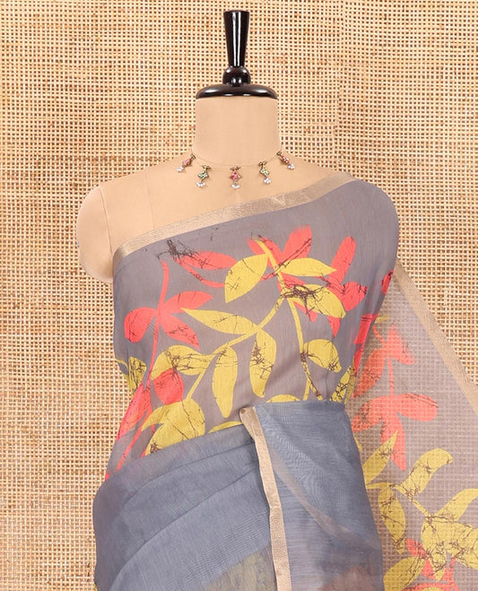 Yellow and grey batik print and leaf vine printed linen saree, zari piping border, printed pallu, and a contrast batik printed blouse