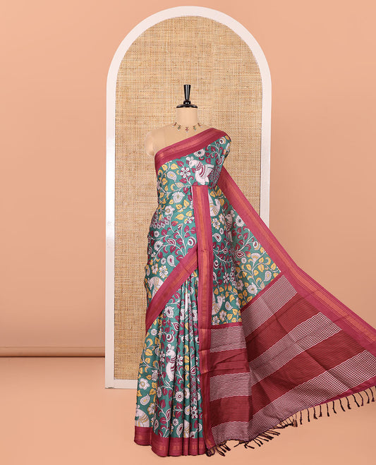 Dark Green Manipuri Silk Saree, Accentuated with Kalamkari-Style Floral Vine and Peacock Motifs Printed All Over Its Body, Complemented by a Contrast Zari Border, Pallu of Chevron Stripes, and Paired with a Contrast Blouse