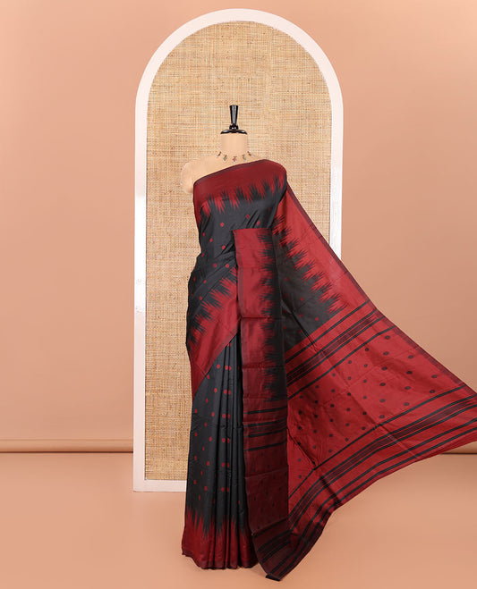 Black Kanchi Silk Saree, Subtly Woven with Flower Buttas All Over Its Body, Complemented by a Contrast Temple Border, Pallu Mirrors the Same Floral Motifs, and Paired with a Contrast Blouse