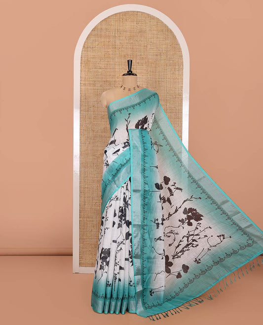 White and Rama Linen Cotton Saree, Bedecked with Silhouette-Style Floral Motifs Printed on Its Body, Complemented by Contrast Bavanji Border, Pallu of Silhouette-Style Floral Print, and Comes with a Matching Blouse
