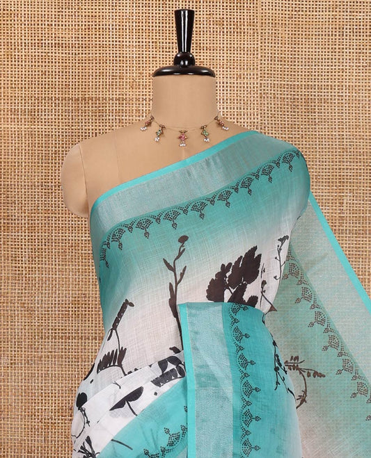 White and Rama Linen Cotton Saree, Bedecked with Silhouette-Style Floral Motifs Printed on Its Body, Complemented by Contrast Bavanji Border, Pallu of Silhouette-Style Floral Print, and Comes with a Matching Blouse