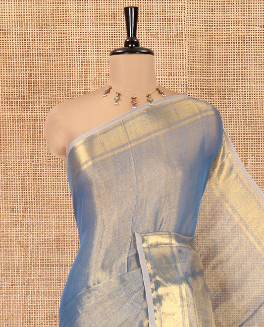 Blue Plain Khadi Tissue Saree, a Gleaming Zari Bavanji Border, Golden Zari Striped Pallu, and Paired with a Matching Blouse
