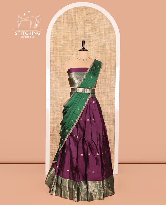 Purple and Green Semi-Banarasi Half-Saree, Beautified with Zari Buttas on Its Skirt, Complemented by a Contrast Traditional Zari Design Woven Border, Paired with a Matching Blouse, and a Contrast Satin Georgette Embroidered Scallop Dhavani