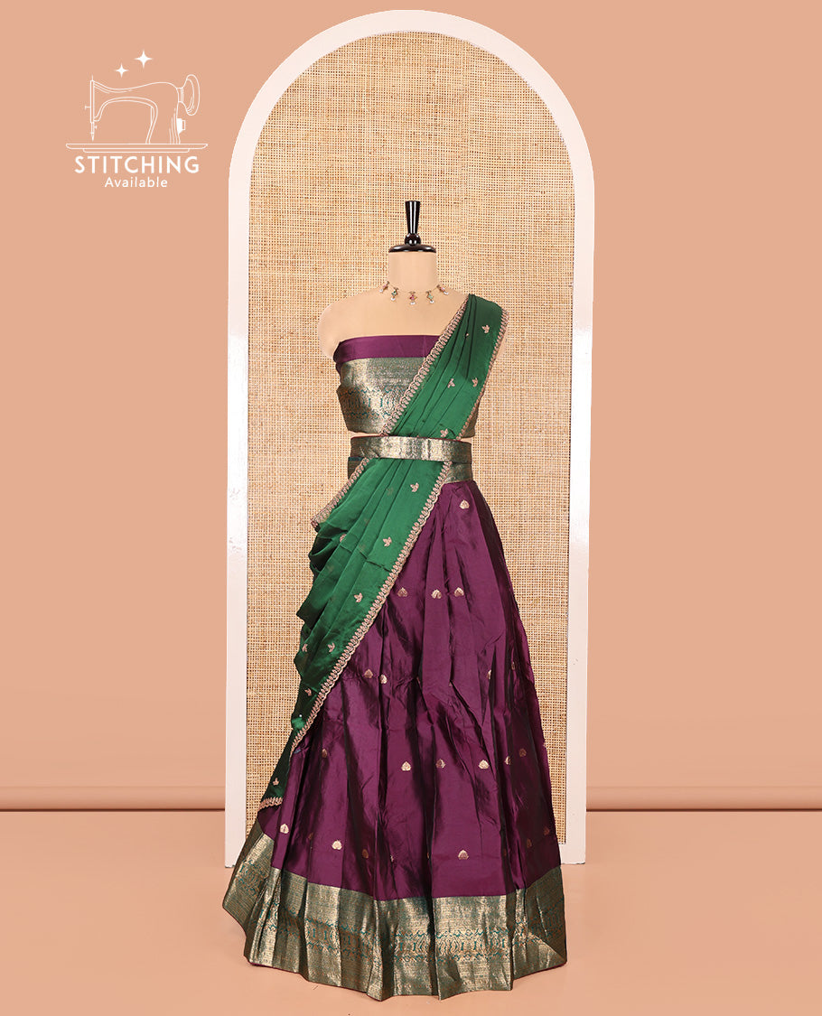 Purple and Green Semi-Banarasi Half-Saree, Beautified with Zari Buttas on Its Skirt, Complemented by a Contrast Traditional Zari Design Woven Border, Paired with a Matching Blouse, and a Contrast Satin Georgette Embroidered Scallop Dhavani