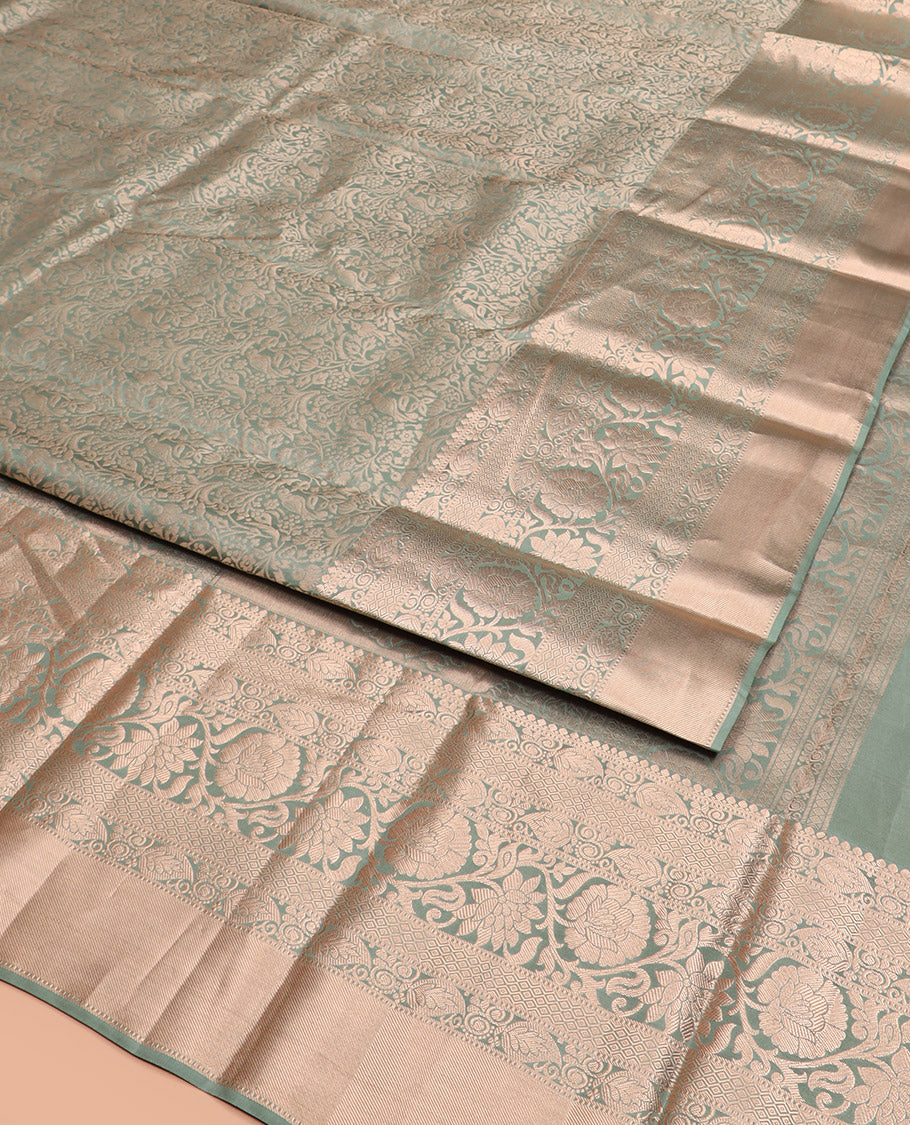Green Kanchipuram Silk Saree Highlighted by Jacquard Design, Complemented by Zari Border of Thilakam Mokku, Manga, Jaal, and Kodi Visiry Designs, Pallu Elevated with Intricate Zari Designs, and Paired with a Matching Blouse